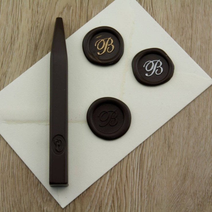 Forest green wax seal impression on invitation envelope